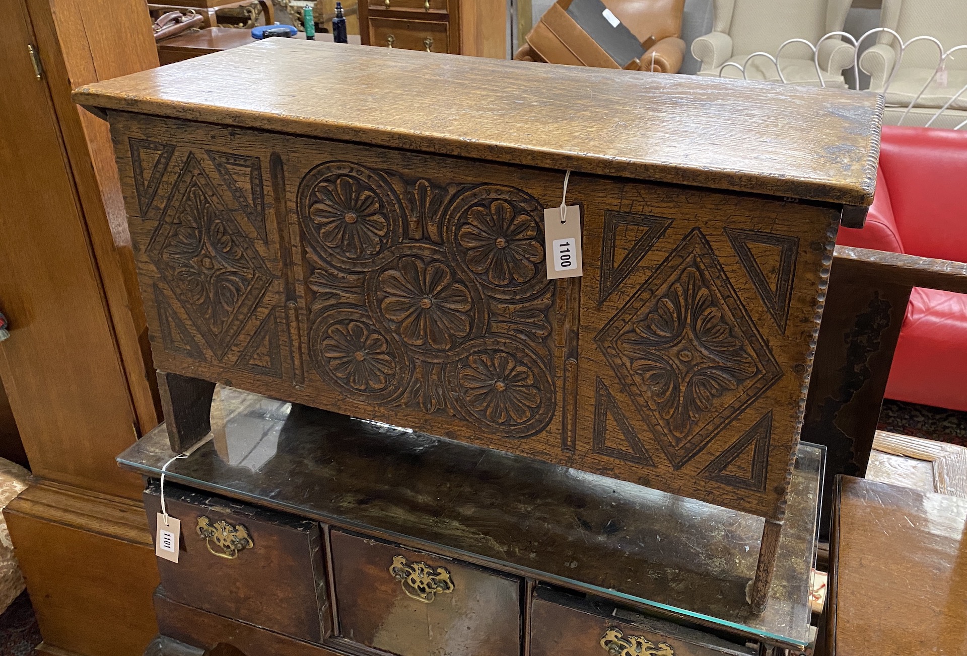 A 17th century style “Sussex” oak six plank coffer with a carved front, width 85cm, depth 36cm, height 51cm